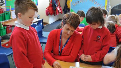 Miss Preston working with children. 